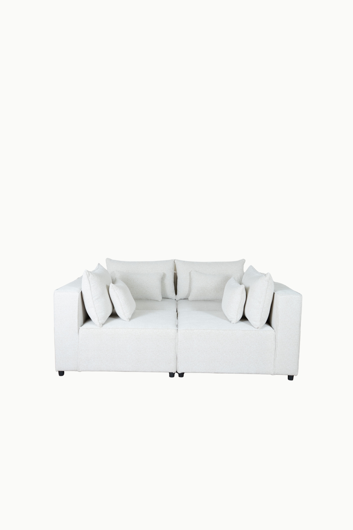 Canapé d'angle modulable en tissu chenille écru, composé de plusieurs modules avec coussins assortis"