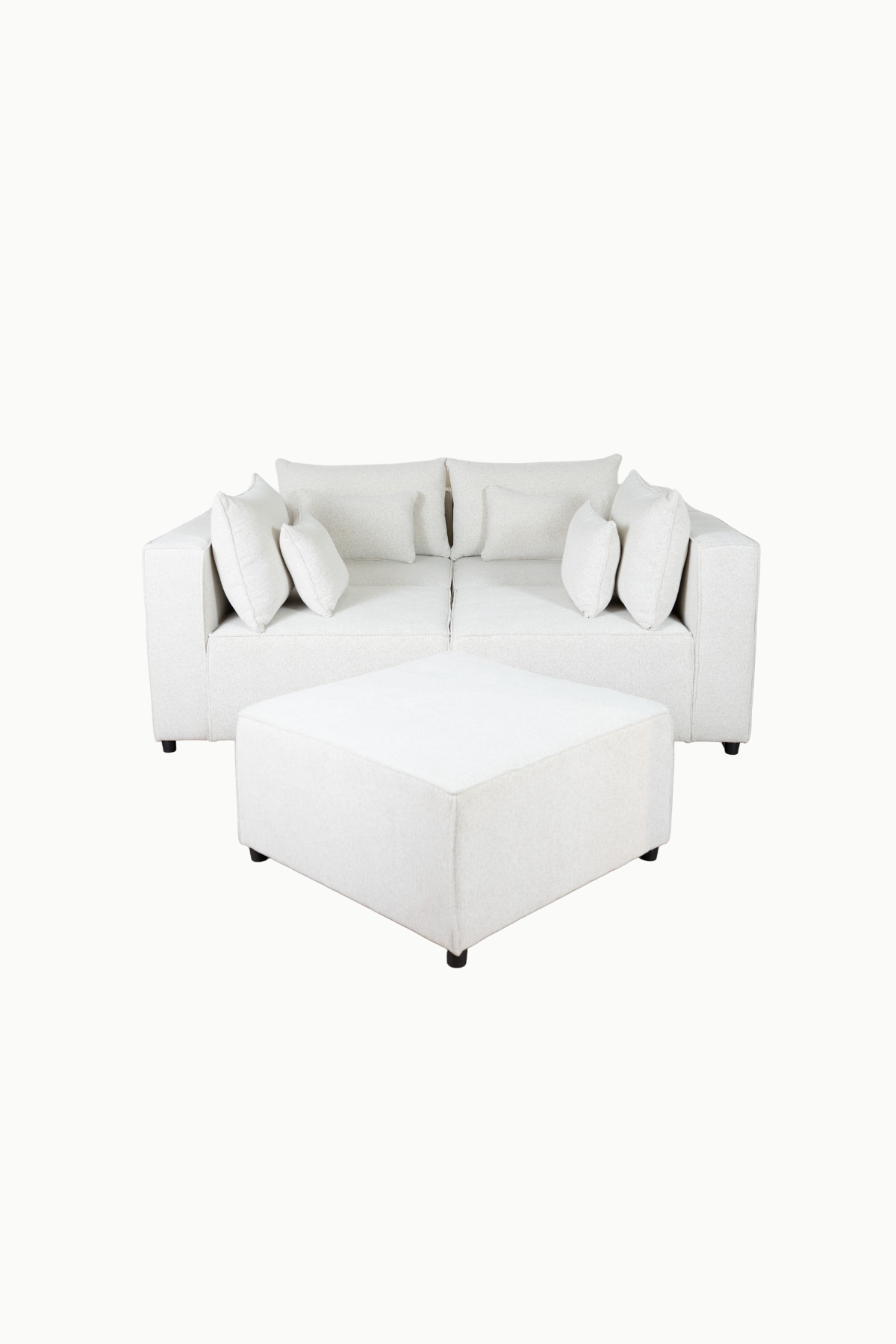 Canapé d'angle modulable en tissu chenille écru, composé de plusieurs modules avec coussins assortis"