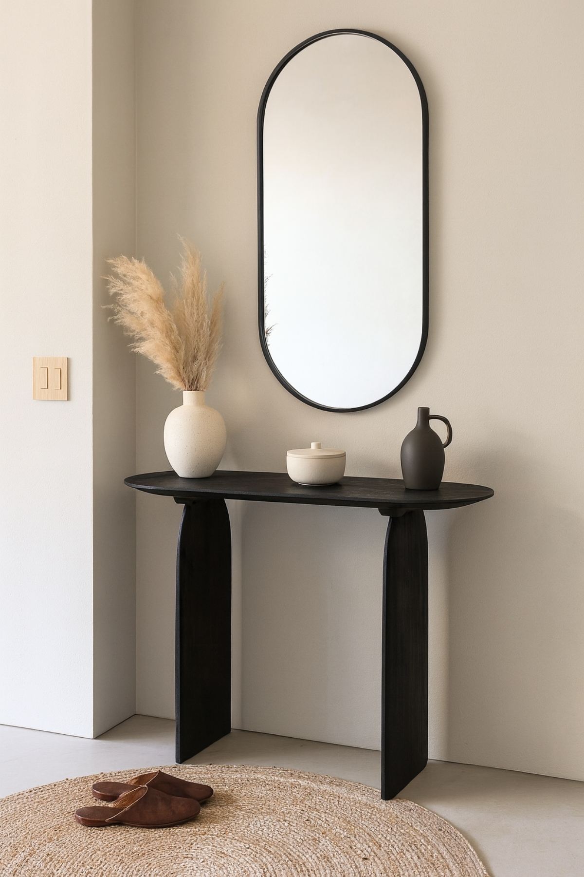 Console Emilia en bois d’acacia noir, design moderne avec plateau ovale et pieds en forme d'arche